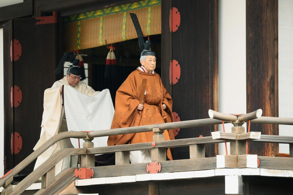 Japan's Emperor Akihito, right, leaves after a ritual to report his abdication to the throne, at the Imperial Palace in Tokyo, Tuesday, April 30, 2019. The 85-year-old Akihito ends his three-decade reign on Tuesday when he abdicates to his son Crown Prince Naruhito. (Japan Pool via AP)