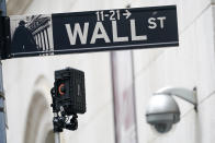 FILE - A Wall Street sign is seen next to surveillance equipment outside the New York Stock Exchange, Tuesday, Oct. 5, 2021, in New York. Stocks are off to a mostly lower start on Wall Street Thursday, Oct. 21, 2021 a day after the S&P 500 and the Dow Jones Industrials approached the record highs they set this summer. (AP Photo/Mary Altaffer)