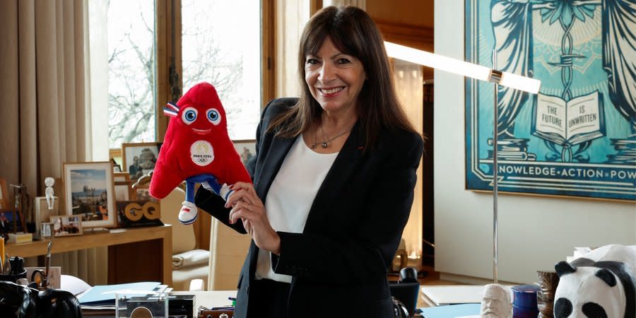 Paris Mayor Anne Hidalgo poses with Friges, the mascot of the 2024 Paris Olympics, during an interview with Reuters at the City Hall in Paris, France, March 13, 2024.