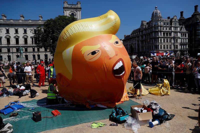 Demonstrators slowly deflate a blimp portraying U.S. President Donald Trump that had been floating over Parliament Square, during the visit by Trump and First Lady Melania Trump, in London