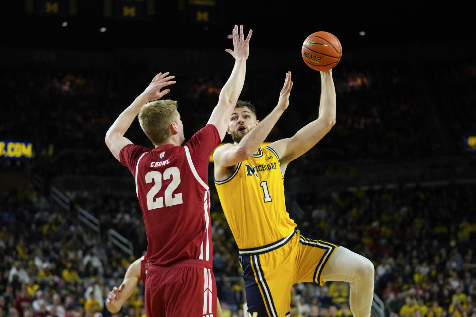 Michigan center Hunter Dickinson (1) shoots on Wisconsin forward Steven Crowl (22) in the second half of an NCAA college basketball game in Ann Arbor, Mich., Sunday, Feb. 26, 2023. (AP Photo/Paul Sancya)