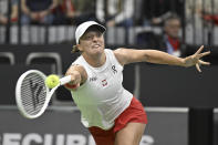 Poland's Iga Swiatek plays the ball during the Billie Jean King Cup qualification round tennis match against Switzerland's Celine Naef in Biel, Switzerland, Saturday, April 13, 2024. (Peter Schneider/Keystone via AP)