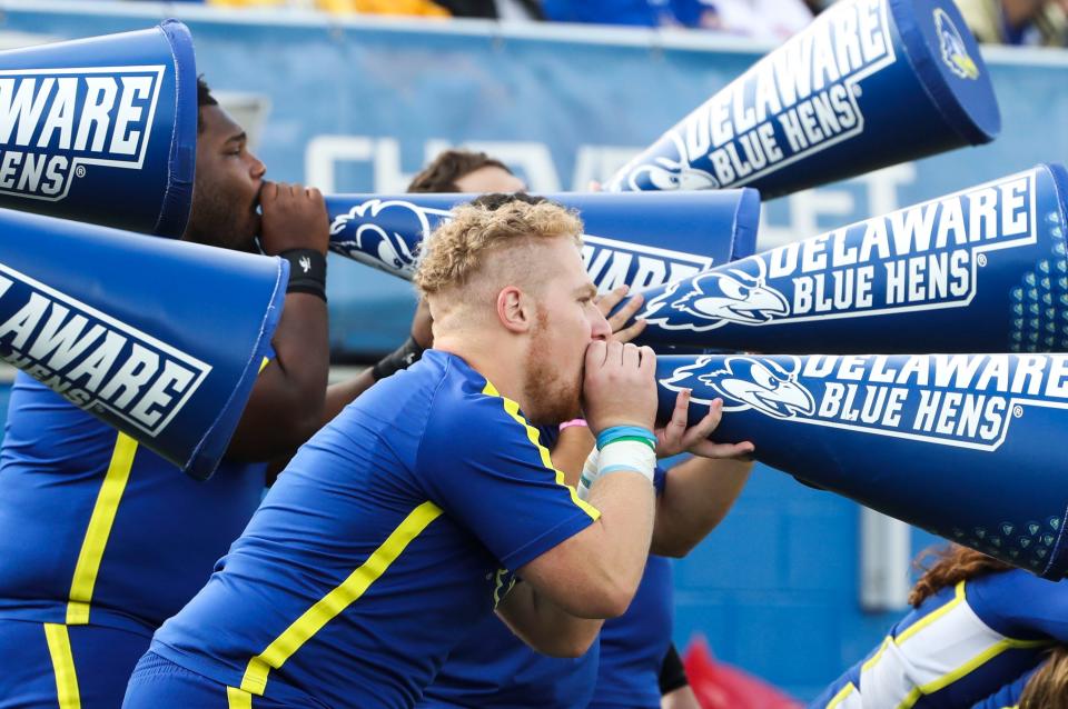 Delaware cheerleaders put their megaphones to use against the Duquesne offense late in the first half at Delaware Stadium, Saturday, Oct. 7, 2023.