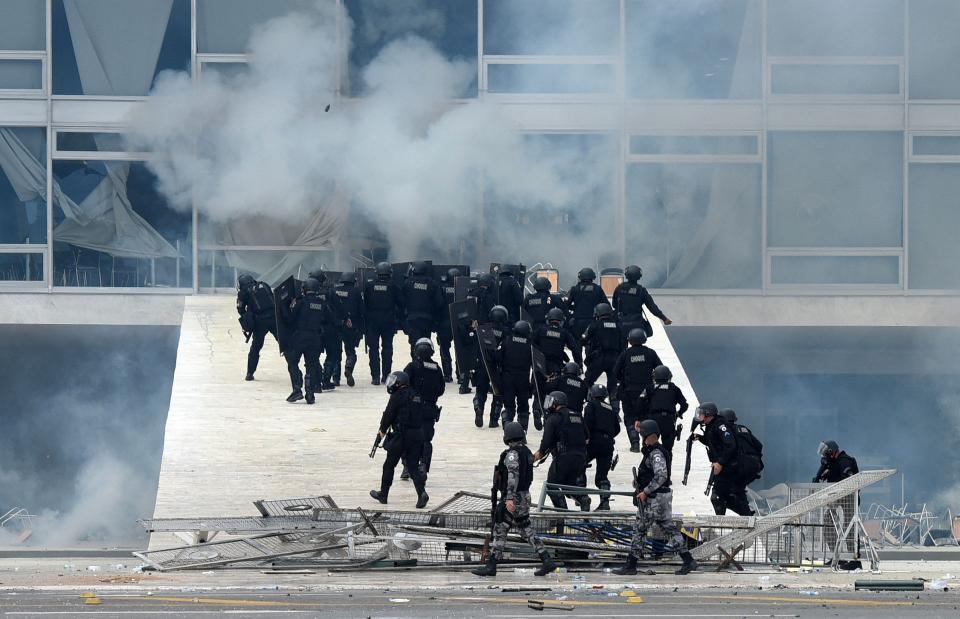 Security forces confront supporters of Brazilian former President Jair Bolsonaro who invaded Planalto Presidential Palace in Brasilia on Sunday.