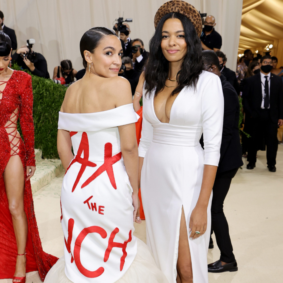 In 2021, New York Rep. Alexandria Ocasio-Cortez, left, was the subject of controversy after wearing a dress that said "Tax the Rich" to the Met Gala. She attended with the dress designer Aurora James of Brother Vellies at a postponed showing in September due to the COVID-19 pandemic.