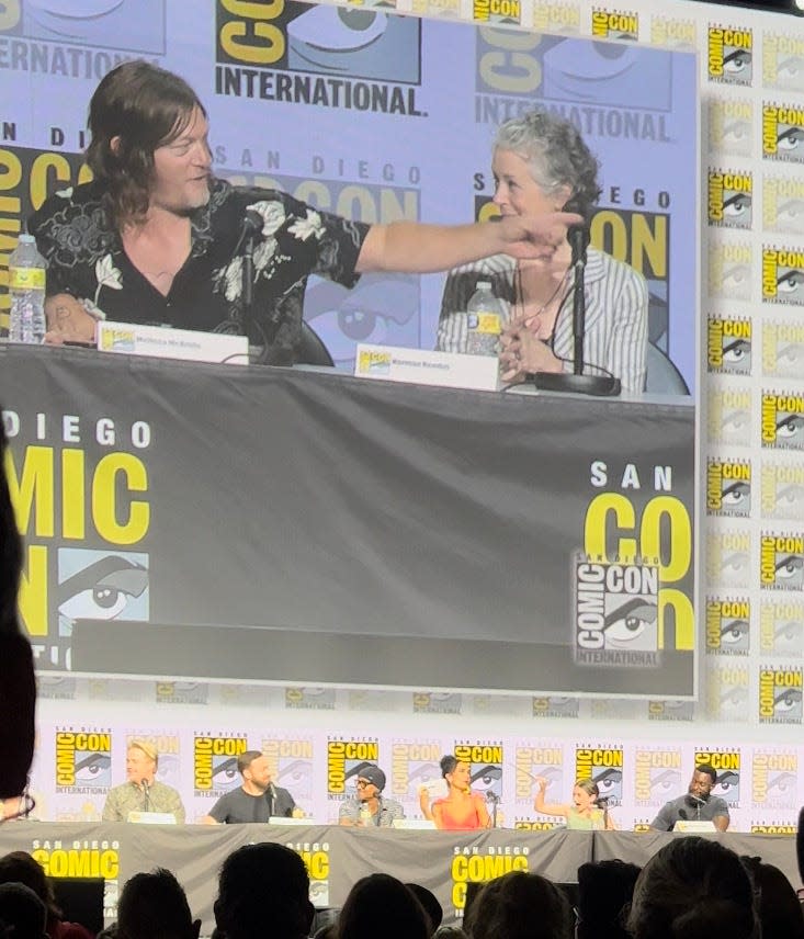 Norman Reedus points to Lauren Ridloff during "TWD" SDCC panel on Friday.