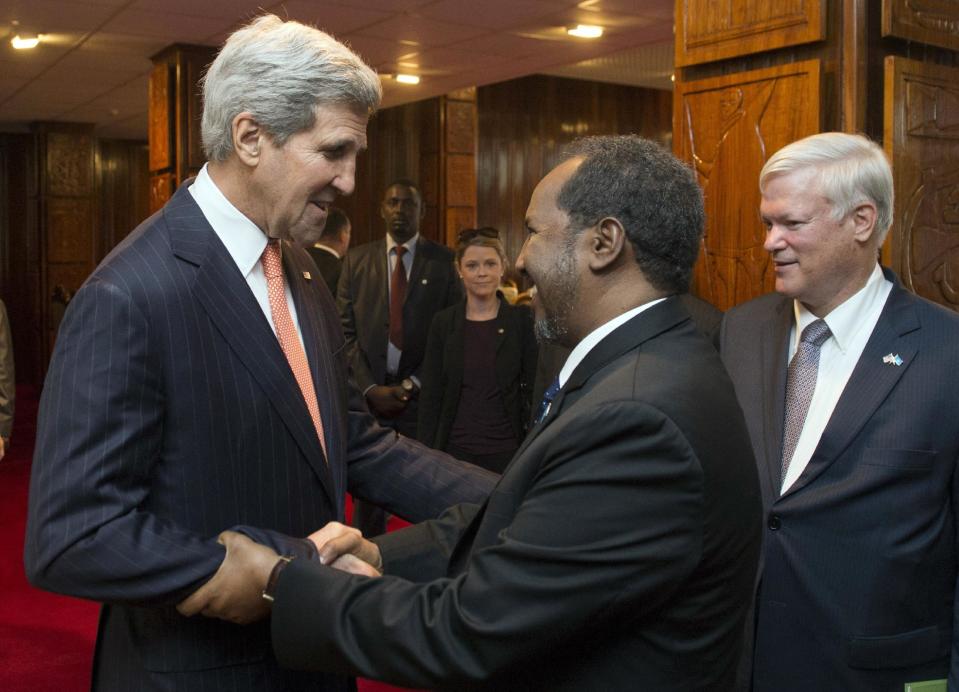 U.S. Secretary of State John Kerry, left, and Somali President Hassan Sheikh Mohamud shake hands prior to a meeting at Addis Ababa Bole International Airport in Addis Ababa, Ethiopia Saturday, May 3, 2014. America's top diplomat said Saturday the U.S. is ready to help increase its ties with Africa, but nations across the continent need to take stronger steps to ensure security and democracy for its people. (AP Photo/Saul Loeb, Pool)