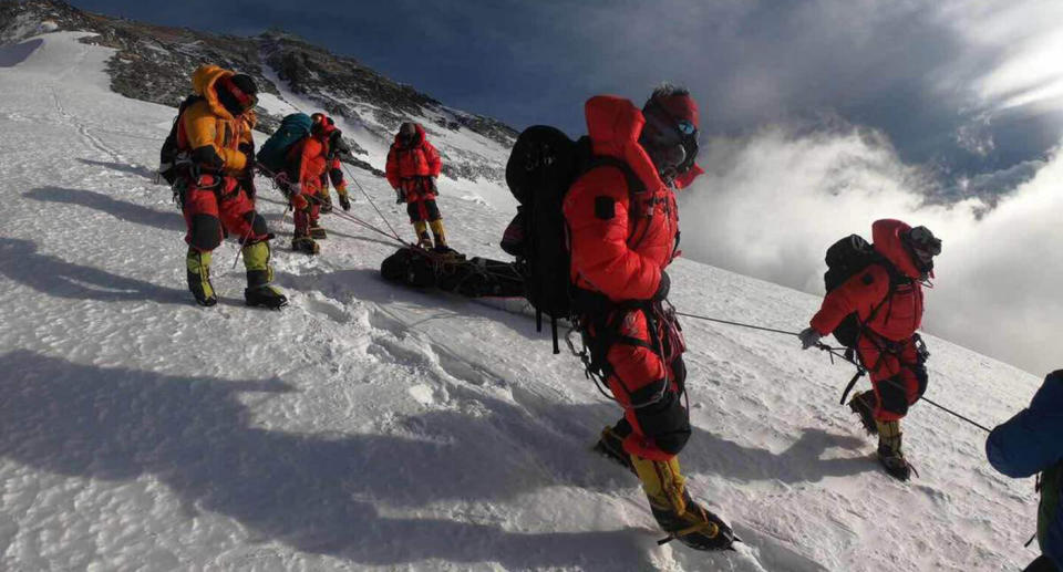 Rescuers help the stranded Australian man to a safe location on Mount Everest.