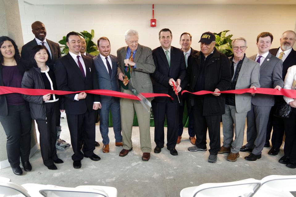 The ribbon cutting for the renovated "Furniture Building" at 93 Centre St. in downtown Brockton, anchored by Concord Square Planning & Development President Ted Carman, left, with scissors, and Mayor Robert Sullivan, right with scissors, on Tuesday, March 26, 2024.