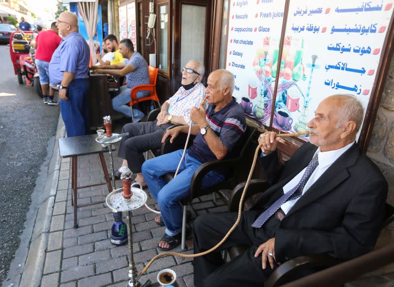 Men smoke hookah in Sidon