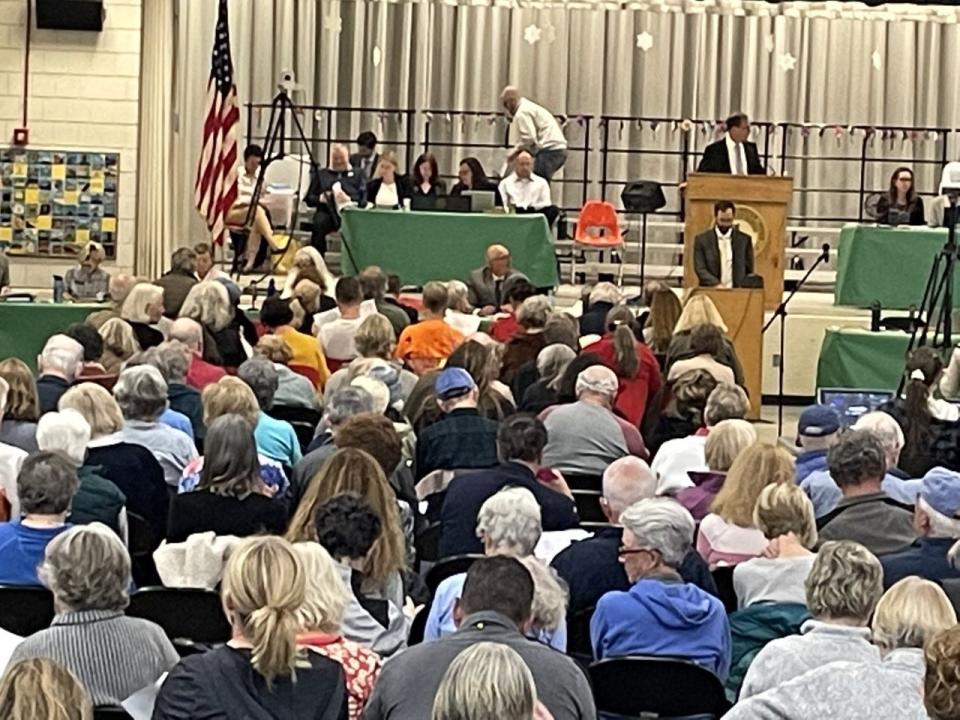 Voters at Brewster's annual town meeting on May 1 listen to presentations on the local and regional school budgets ahead of voting on overrides to help support them.