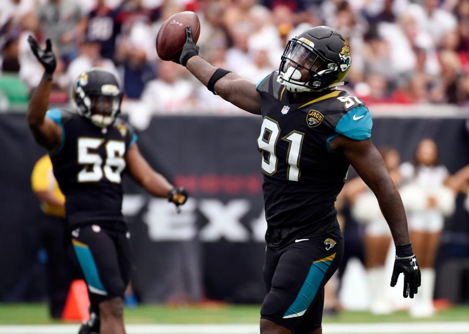 FILE- In this Sept. 10, 2017, file photo, Jacksonville Jaguars defensive end Yannick Ngakoue (91) celebrates after he recovered a fumble by Houston Texans quarterback Deshaun Watson during the second half of an NFL football game in Houston. The second-year pro led the NFL with six forced fumbles in the regular season and added another one last week at Pittsburgh. Ngakoue would love to add New England's Tom Brady to his growing resume in the AFC championship game. (AP Photo/Eric Christian Smith, File)