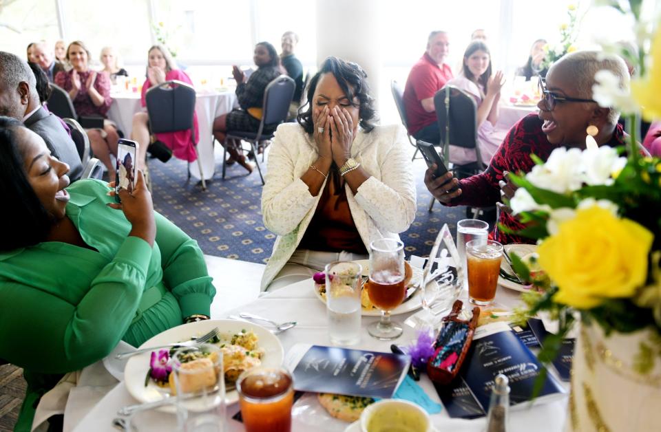 Katrina D. Worsham reacts when she hears she is the Holy Angels Virginia K. Shehee Most Influential Woman Award winner during the eighth annual award luncheon at East Ridge Country Club Thursday, March 7, 2024.