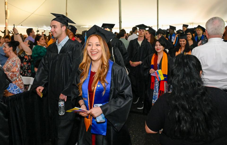 Graduates proceed into the tent during the MassBay Community College's commencement exercises, May 23, 2024.