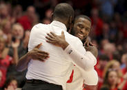 Dayton's Jalen Crutcher, right, hugs head coach Anthony Grant, left, during the second half of an NCAA college basketball game against George Washington, Saturday, March 7, 2020, in Dayton, Ohio. (AP Photo/Tony Tribble)
