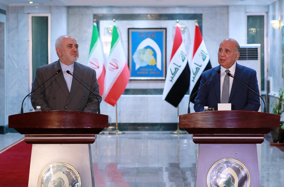 Iraqi Foreign Minister Fouad Hussein, right, and visiting Iranian counterpart Mohammad Javad hold a news conference following their meeting in Baghdad, Iraq, Sunday, July 19, 2020. (AP Photo/Hadi Mizban)