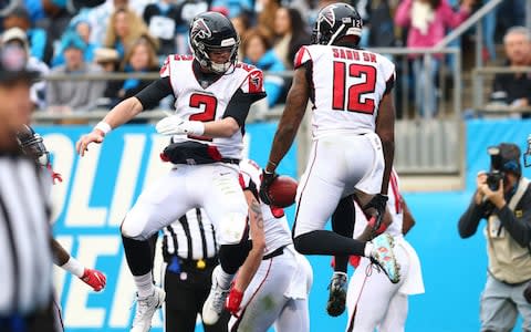 Atlanta Falcons quarterback Matt Ryan (2) celebrates with wide receiver Mohamed Sanu (12) after a touchdown in the third quarter against the Carolina Panthers at Bank of America Stadium - Credit: USA TODAY