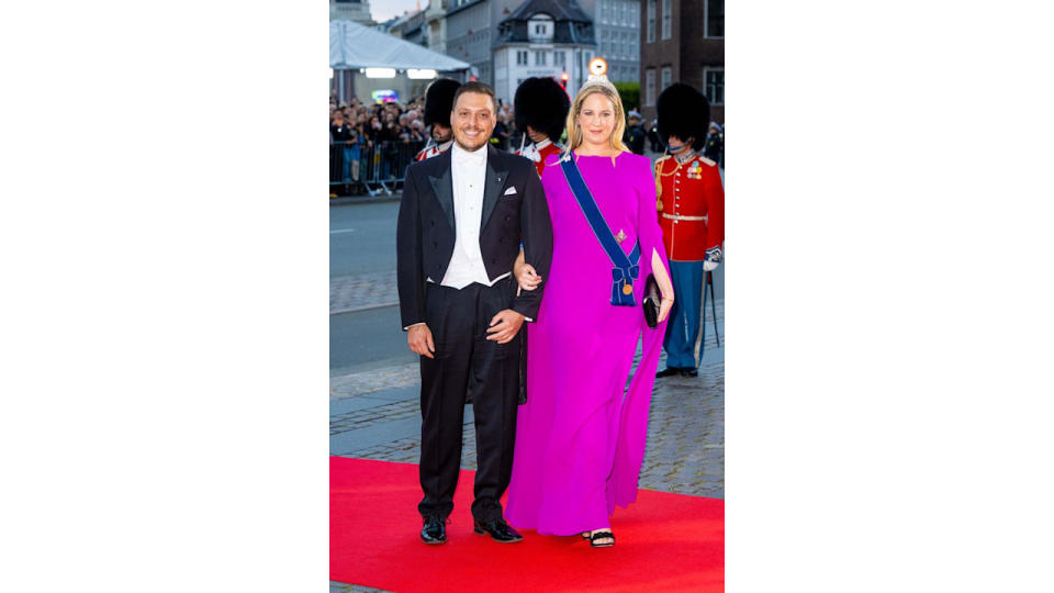 Matthew Kumar in a black suit and Princess Theodora wearing a pink dress