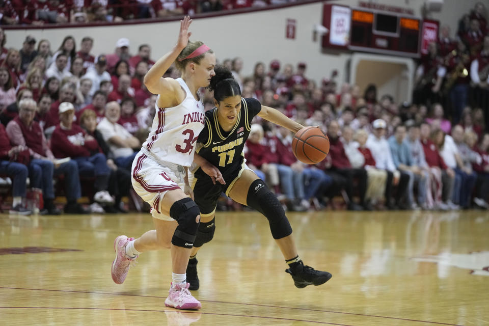 Purdue's Lasha Petree (11) goes to the basket against Indiana's Grace Berger (34) during the first half of an NCAA college basketball game, Sunday, Feb. 19, 2023, in Bloomington, Ind. (AP Photo/Darron Cummings)