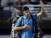 Novak Djokovic of Serbia waves after withdrawing from his match against Feliciano Lopez of Spain at the ATP Dubai Duty Free Tennis Championships February 25, 2016. REUTERS/Ahmed Jadallah
