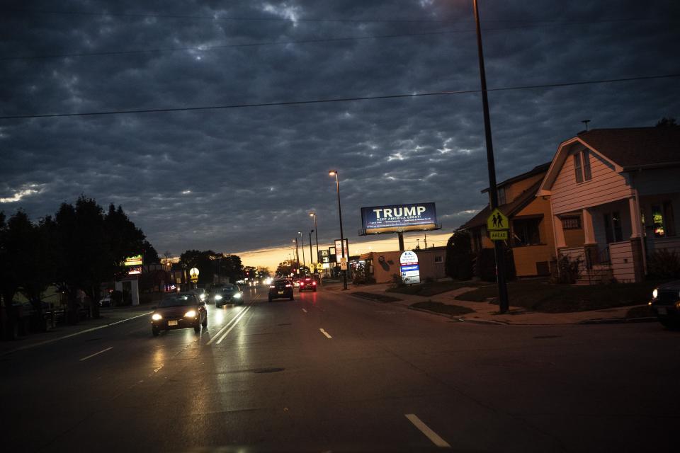 A Trump billboard is illuminated along a street, Saturday, Oct. 31, 2020, in Kenosha, Wis. President Donald Trump has made protest violence in Kenosha and other American cities, a key part of his re-election campaign, linking violence to Democrats and saying it would spread dramatically if Democratic nominee and former Vice President Joe Biden was to defeat him on Election Day. (AP Photo/Wong Maye-E)