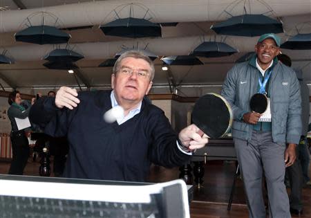 International Olympic Committee (IOC) President Thomas Bach plays table tennis during a ceremony in the Coastal Cluster Olympic Village in Sochi, February 4, 2014. REUTERS/Eric Gaillard