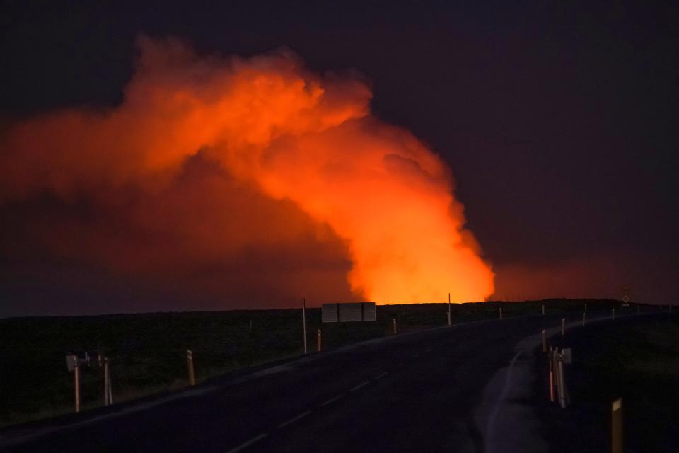 A view of the plume of gas lighted up by the lava from the erupting volcano seen from Suðurstrandavegur