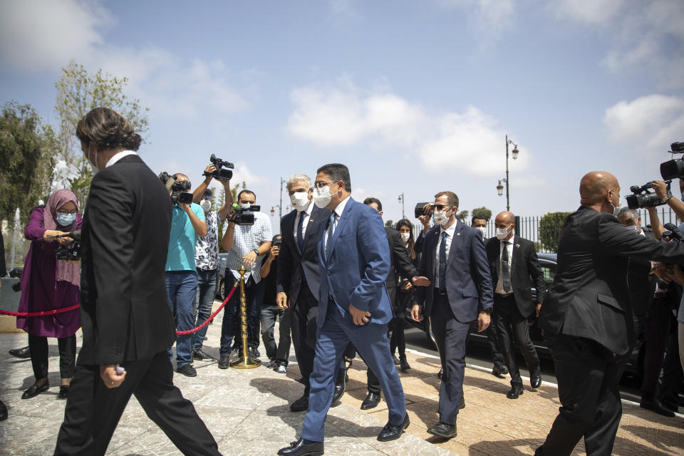 Moroccan Foreign Minister Nasser Bourita, centre right, welcomes Israeli Foreign Minister Yair Lapid, centre left, in Rabat, Morocco, Wednesday, Aug. 11, 2021. The Israeli Foreign Minister Yair Lapid is on an official visit to Morocco. (AP Photo/Mosa'ab Elshamy)