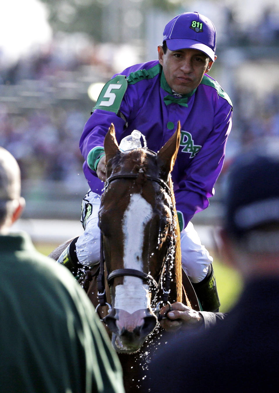 Victor Espinoza pours water on California Chrome after riding to a victory during the 140th running of the Kentucky Derby horse race at Churchill Downs Saturday, May 3, 2014, in Louisville, Ky. (AP Photo/David Goldman)