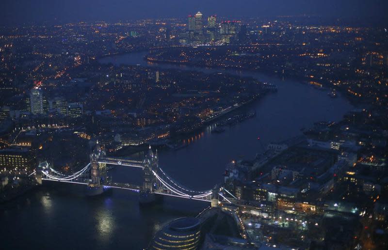 Tower Bridge and the Canary Wharf financial district are seen at dusk in an aerial photograph from The View gallery at the Shard, western Europe's tallest building, in London