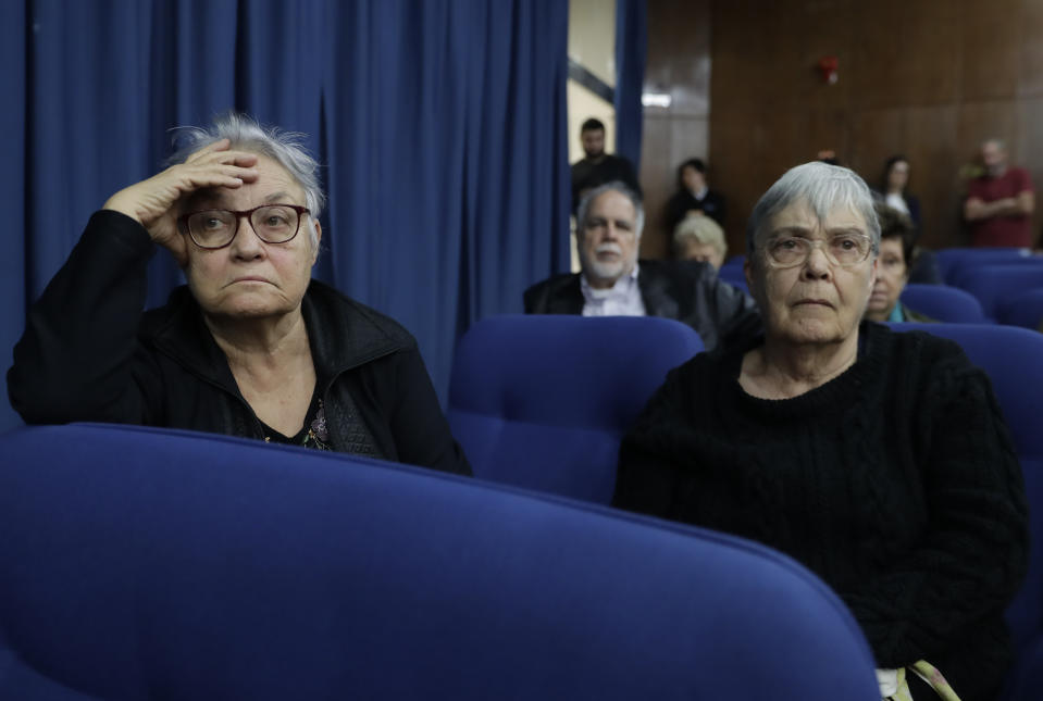 Maria Amelia de Almeida Teles, left, and her sister Crimeia Alice Schmidt de Almeida attend a press conference about the decision by President Jair Bolsonaro to dismiss several members of a commission investigating disappearances and murders committed during Brazil's dictatorship, in Sao Paulo, Brazil, Thursday, Aug. 1, 2019. According to the Almeida sisters, they were detained and tortured by soldiers in 1972, when Crimeia was 8-months pregnant. (AP Photo/Andre Penner)