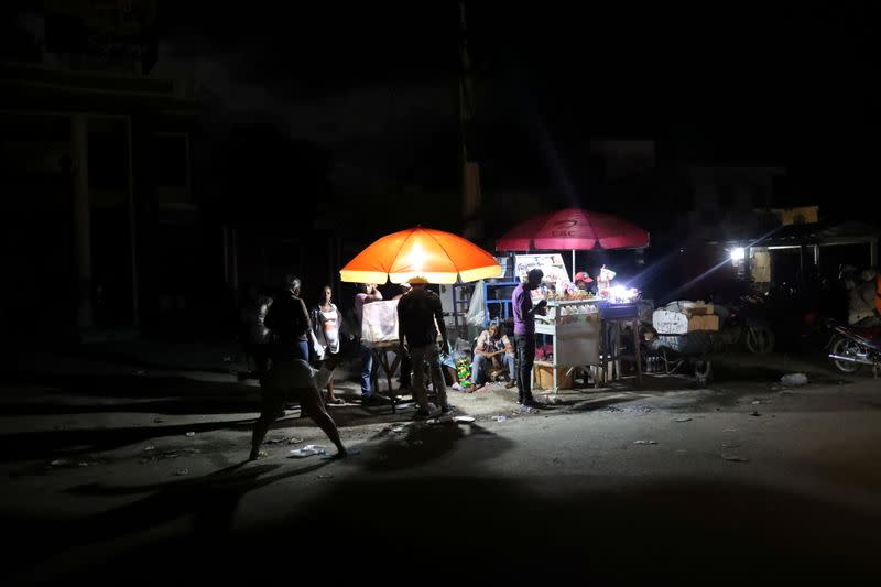 People are seen outside their home after tremors shook buildings, following Saturday's earthquake in Les Cayes, Haiti