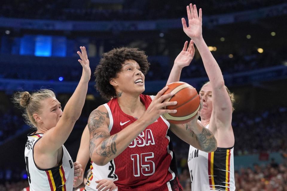 American Brittney Griner, center, shoots under pressure from Belgium's Elisa Ramette and Emma Meesseman