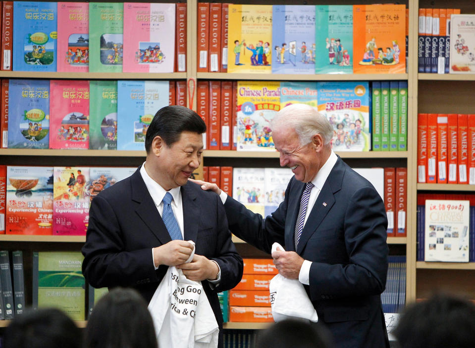 Xi Jinping and U.S. Vice President Biden hold T-shirts students gave them at the International Studies Learning Center in South Gate, California, on Feb. 17 2012.<span class="copyright">Damian Dovarganes—AP Chinese Vice-President</span>