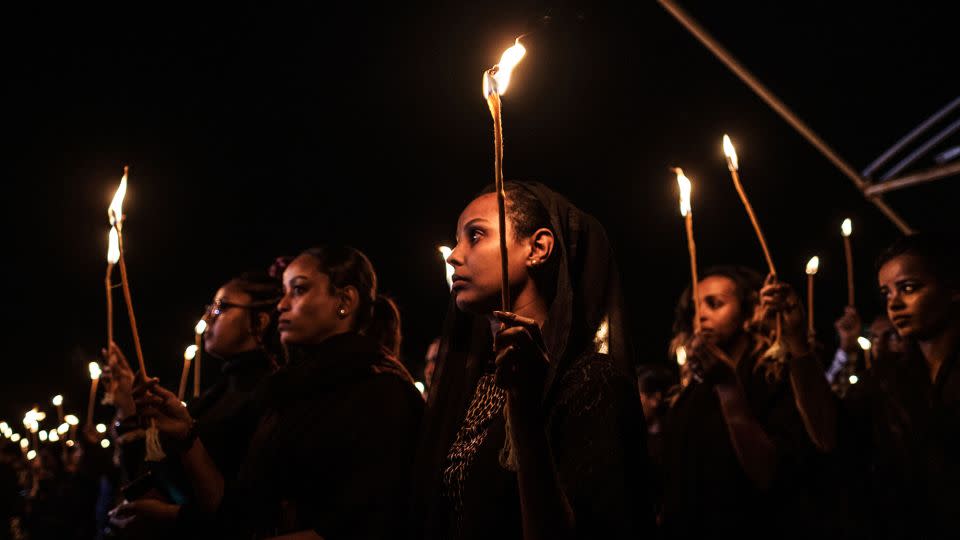 Relatives and colleagues of the Ethiopian Airlines' crew victims hold candles during a commemoration of the 2019 crash of the a Boeing 737 Max. - Eduardo Soteras/AFP/Getty Images