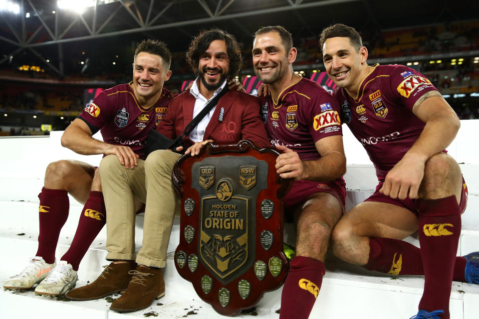 Cooper Cronk, Johnathan Thurston, Cameron Smith and Billy Slater smile and pose with the State of Origin Trophy in 2017.