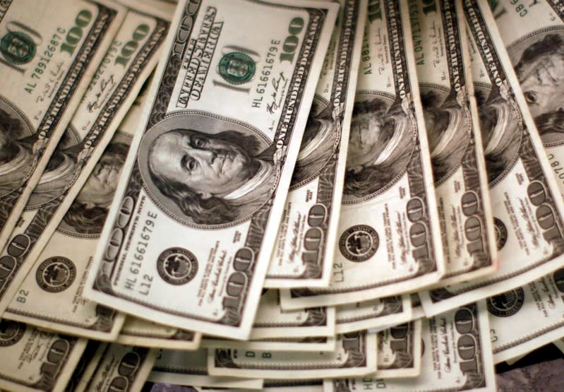 FILE PHOTO: U.S. dollars are counted at a bank in Westminster, Colorado.