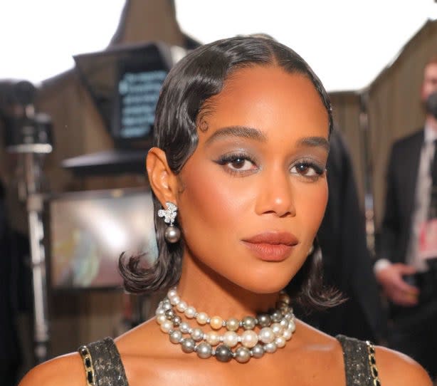 Laura Harrier with '20s style hair and pearl jewelry