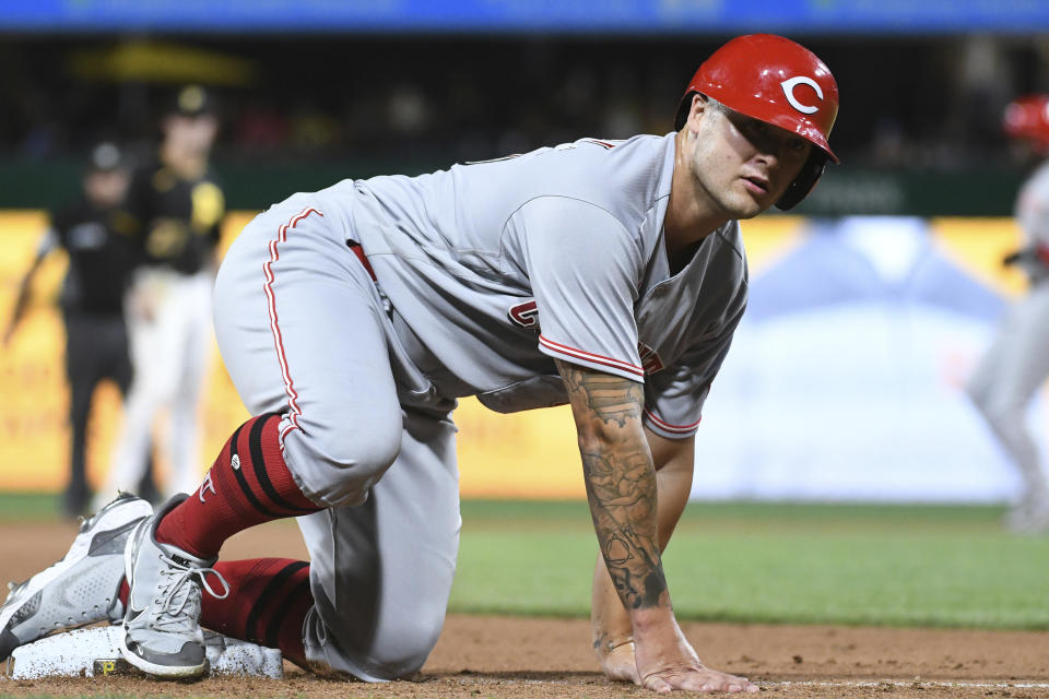 Cincinnati Reds' Nick Senzel slides into third base on a single by Aristides Aquino against the Pittsburgh Pirates during the ninth inning of a baseball game, Friday, Aug. 19, 2022, in Pittsburgh. (AP Photo/Philip G. Pavely)