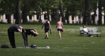 People exercise in St James Park in London, Sunday, May 10, 2020 during the nation-wide coronavirus lockdown. Personal exercise while observing social distancing measures is allowed under government lockdown guidelines. (AP Photo/Frank Augstein)