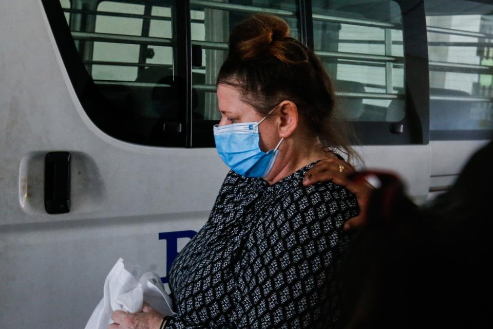 British national Samantha Jones, accused of killing her husband in 2018, is escorted by a police officer to a van after appearing in court in Alor Setar, in northern Malaysia, on August 3, 2020. - A British woman was jailed for three and a half years on August 3, after tearfully admitting she stabbed her husband to death during a fight on the Malaysian holiday island of Langkawi. (Photo by A. Ammarudin / AFP) (Photo by A. AMMARUDIN/AFP via Getty Images)