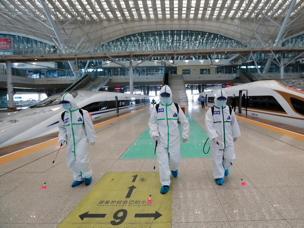 In this photo released by Xinhua News Agency, firefighters conduct disinfection on the platform of Wuhan Railway Station in Wuhan, central China's Hubei Province, March 24, 2020. Chinese authorities said Tuesday they will end a two-month lockdown of most of coronavirus-hit Hubei province at midnight, though the provincial capital will remain closed til April 8, as domestic cases of the virus continue to subside.(Zhao Jun/Xinhua via AP)