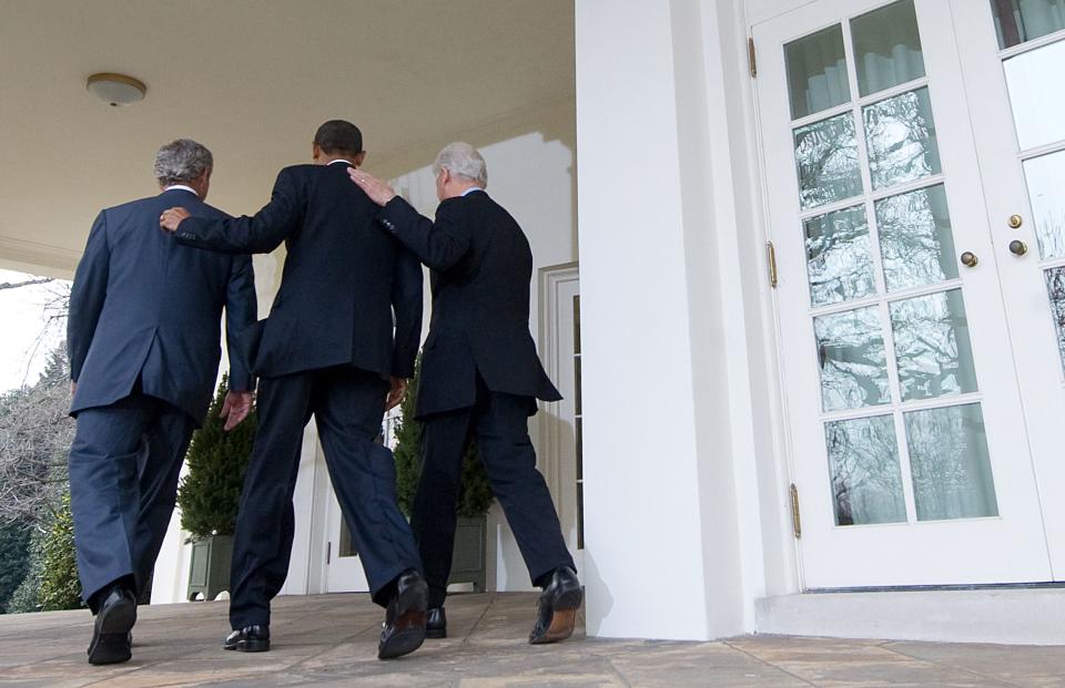 President Barack Obama, center, walks to the Oval Office alongside former Presidents Bill Clinton, right, and George W. Bush, after speaking about relief efforts following the earthquake in Haiti, during a statement in the Rose Garden of the White House in Washington, January 16, 2010.