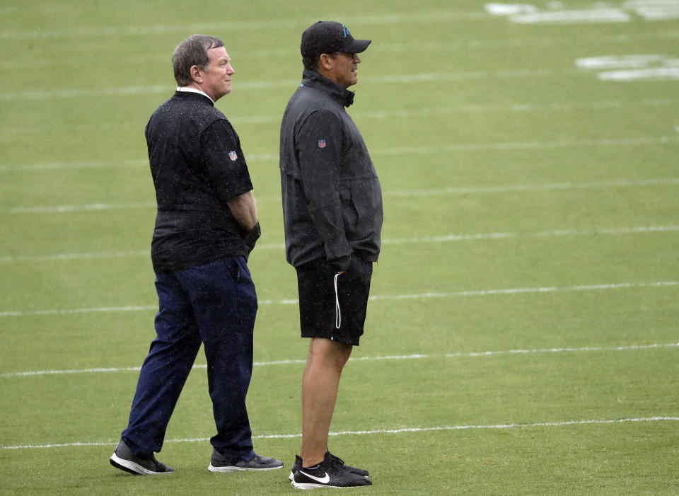 Carolina Panthers head coach Ron Rivera, right, and general manager Marty Hurney, left, watch practice during the NFL football team's rookie camp in Charlotte, N.C., Friday, May 10, 2019. (AP Photo/Chuck Burton)
