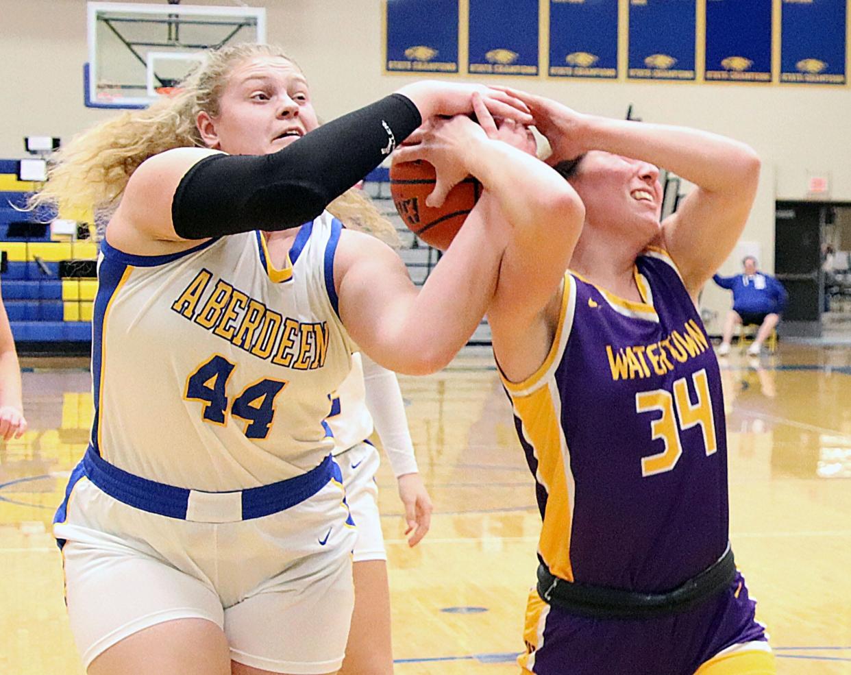 Aberdeen Central's Taryn Hermansen (left) and Watertown's Avery Munger battle for a rebound during their high school girls basketball game on Tuesday, Feb. 13, 2024 at Aberdeen Central High School. Watertown won 55-46.