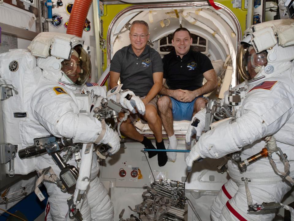 In this June 26, 2020 photo made available by NASA, spacewalkers Bob Behnken, foreground left, and Chris Cassidy, foreground right, are suited up with assistance from Expedition 63 Flight Engineers Doug Hurley, center left, and Ivan Vagner in the International Space Station. On Wednesday, July 29, 2020, SpaceX and NASA cleared the Dragon crew capsule to depart the International Space Station and head home after a two-month flight.