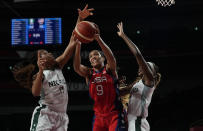 United States' A'Ja Wilson (9), center, grabs a rebound between Nigeria's Adaora Elonu (11), left, and Atonye Nyingifa (21) during women's basketball preliminary round game at the 2020 Summer Olympics, Tuesday, July 27, 2021, in Saitama, Japan. (AP Photo/Eric Gay)