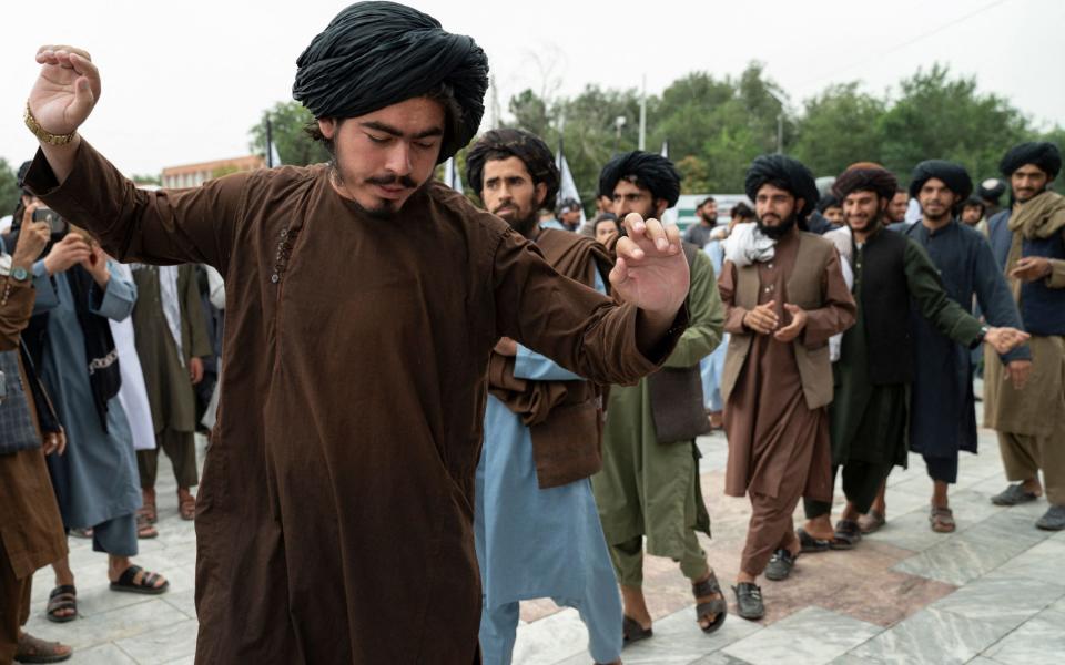 Taliban fighters dancing in the streets in 2022 after the US pulled out