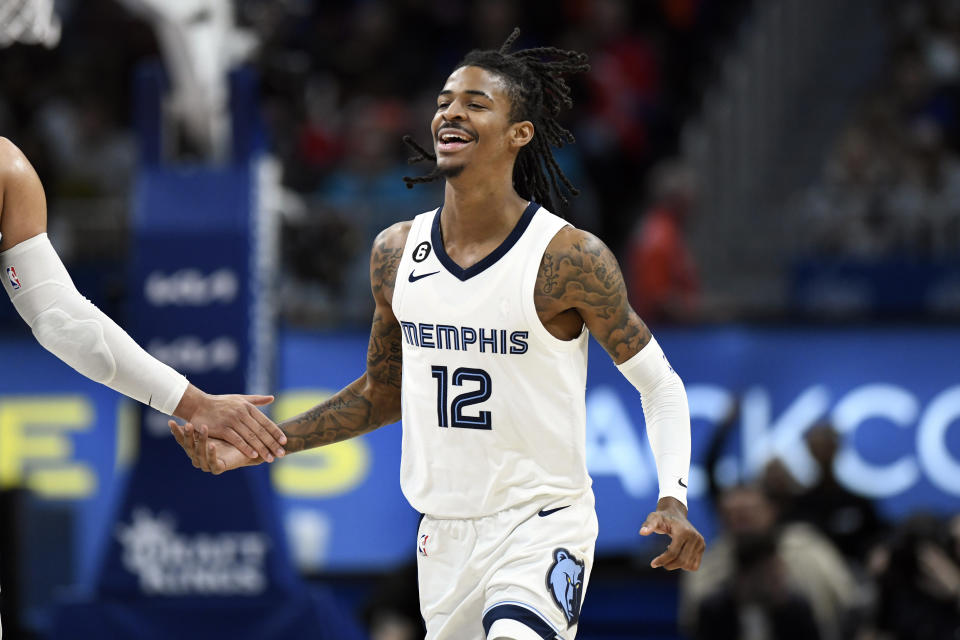 Memphis Grizzlies guard Ja Morant reacts after dunking against the Detroit Pistons during the second half of an NBA basketball game, Sunday, Dec. 4, 2022, in Detroit. (AP Photo/Jose Juarez)