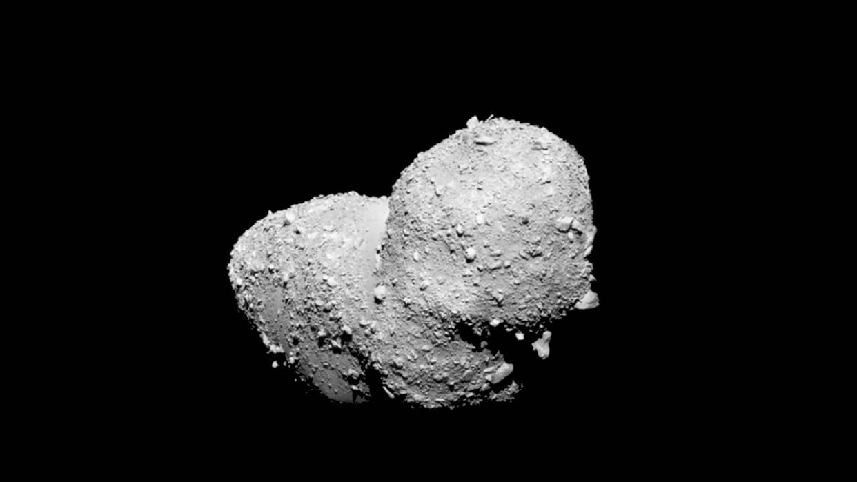  a rocky peanut-shaped asteroid in space 